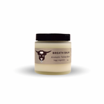 Jar of breath balm with a black lid on a white background