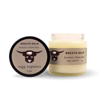 Two containers of tagg organics Breath Balm on a white background