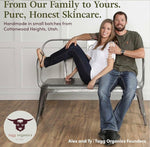 Two people sitting on a metal bench with text about pure, honest skincare from Tagg Organics.