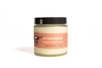 Jar of 'Citrus Dream' whipped tallow cream on a white background
