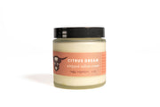 Jar of 'Citrus Dream' whipped tallow cream on a white background