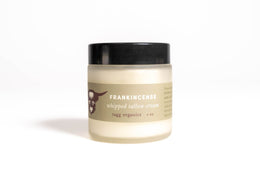 Jar of frankincense whipped tallow cream on a white background