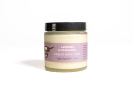 Jar of lavender and chamomile whipped tallow cream on a white background
