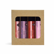 Set of four lip balm sticks in a cardboard packaging box on a white background